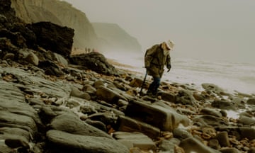 Richard Forrest walks along Lyme Regis beach in Dorset, where he regularly hunts for fossils.