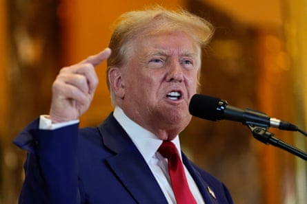 Trump gesticulating angrily at a mic.