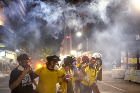 Members of Moms United for Black Lives Matter hold their ground as federal officers fire tear gas into a protest on July 29, 2020 in Portland, Oregon.
