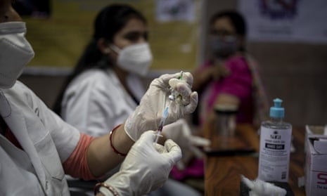 A health worker prepares to administer a Covid vaccine to a woman at a government hospital in Noida, a suburb of Delhi, on Monday.