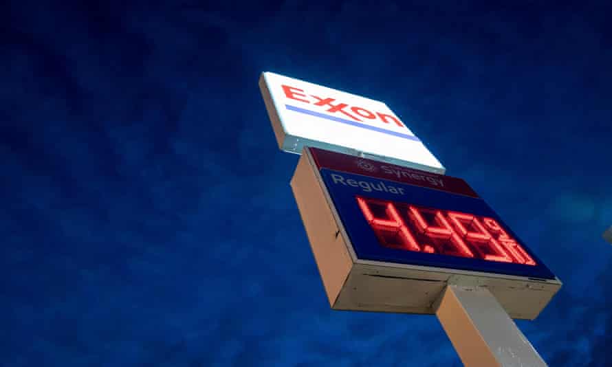A sign displays $4.49 a gallon at an Exxon gas station in Washington DC on 13 March.