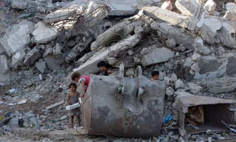 Palestinian children play in the rubble of buildings in Gaza City that were destroyed by Israel in the summer of 2014. 