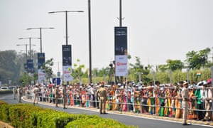 People wait beside a street to catch a glimpse of US president Donald Trump’s motorcade in Ahmedabad