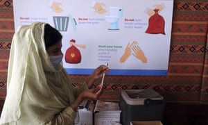 A health worker prepares a Pfizer COVID-19 vaccine at a vaccination center in Islamabad, Pakistan.
