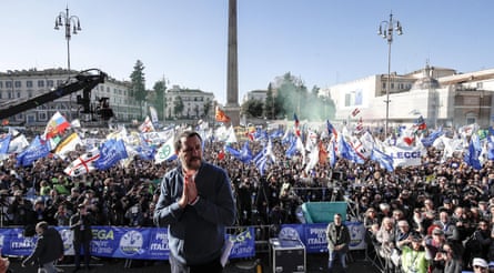 Matteo Salvini on stage before a large crowd at a League party rally