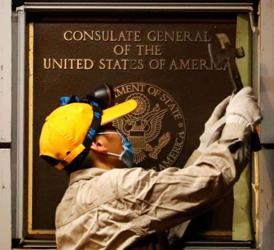 A man removes the US consulate plaque in Chengdu, Sichuan province