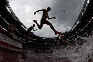 Athletes compete in the men’s 3000m steeplechase heats.