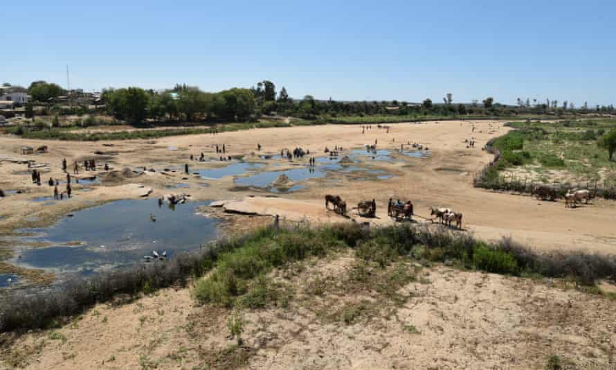 People living in and around Tsihombe, Madagascar, gather at holes dug to access water.