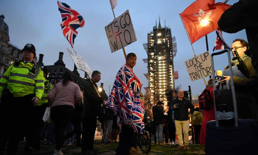 Brexit supporters carry flags and placards as they walk gather in Parliament Square