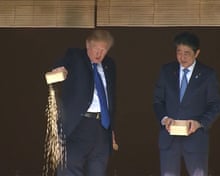 Fishy business: Trump and Abe dump fish food into precious koi pond | Donald Trump | The Guardian Fishy business: Trump and Abe dump fish food into precious koi pond | Donald Trump | The Guardian