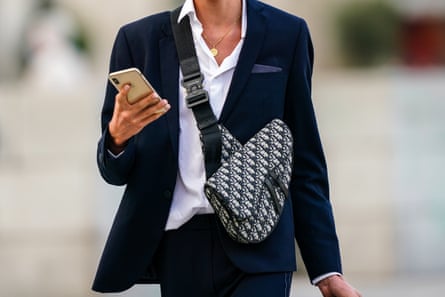 A person wears a handbag slung over their body