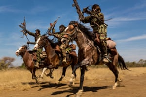 Nature, second prize, stories - Brent StirtonIvory wars: rangers from a horse patrol group exhibit their riding skills as they return to base at Zakouma national park, Chad, after weeks on elephant patrol