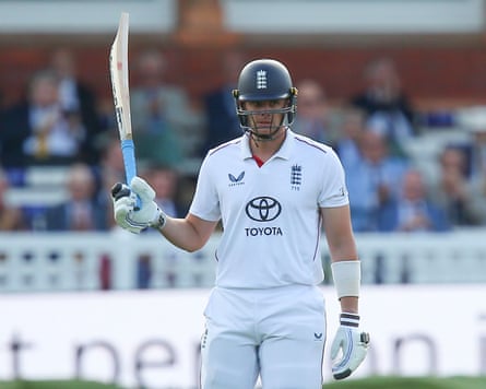 Jamie Smith raises his bat to the crowd