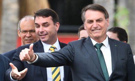 Jair Bolsonaro with his son Flávio. Documents and mobile phones were reportedly seized as 24 warrants were executed in the cities of Rio and Resende.