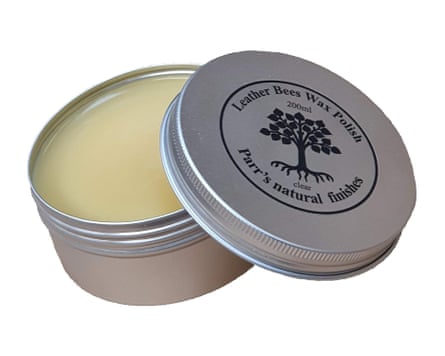 A tin of Parr’s Beeswax Leather Balsam. The lids rests on the edge of the tin and has Parr’s logo on the top.