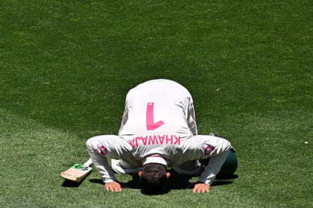 Khawaja prostrates himself to the ground in a traditional Islamic prayer position before leaving the field