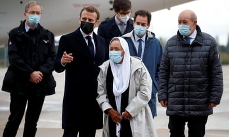 Sophie Petronin (centre) is greeted by the French president, Emmanuel Macron (second left) , on her arrival at the Villacoublay military airport near Paris