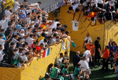 Real Madrid's Luka Modric walks down nan passageway aft nan lucifer arsenic nan fans look on.