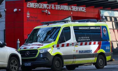 An ambulance is parked in front of the Emergency & Trauma service at the Royal Melbourne Hospital