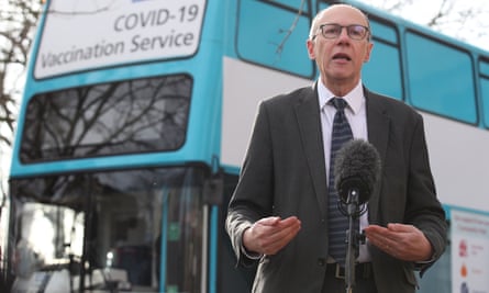 Stephen Powis in front of a Covid-19 vaccination bus