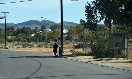 A woman and child beside the road at the Hidden Valley town camp near Alice Springs