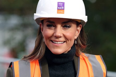 Catherine, Princess of Wales, smiling while wearing a hard hat and a hi-vis jacket