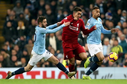 Bernardo Silva of Manchester City challenges Roberto Firmino of Liverpool in a Premier League match in January 2019