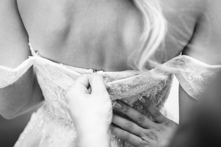 a woman putting on a dress