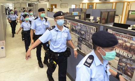 Police officers inside Apple Daily headquarters
