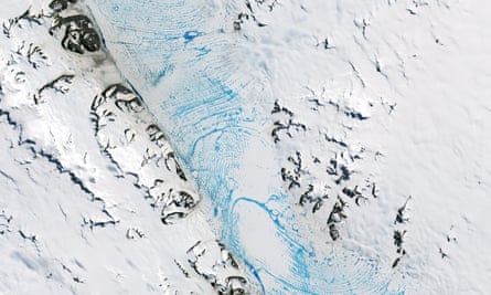 Blue meltwater spans a vast area on the George VI ice shelf in Antarctica