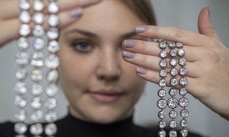 A Christie's employee holds up a pair of diamond bracelets once owned by Marie Antoinette.