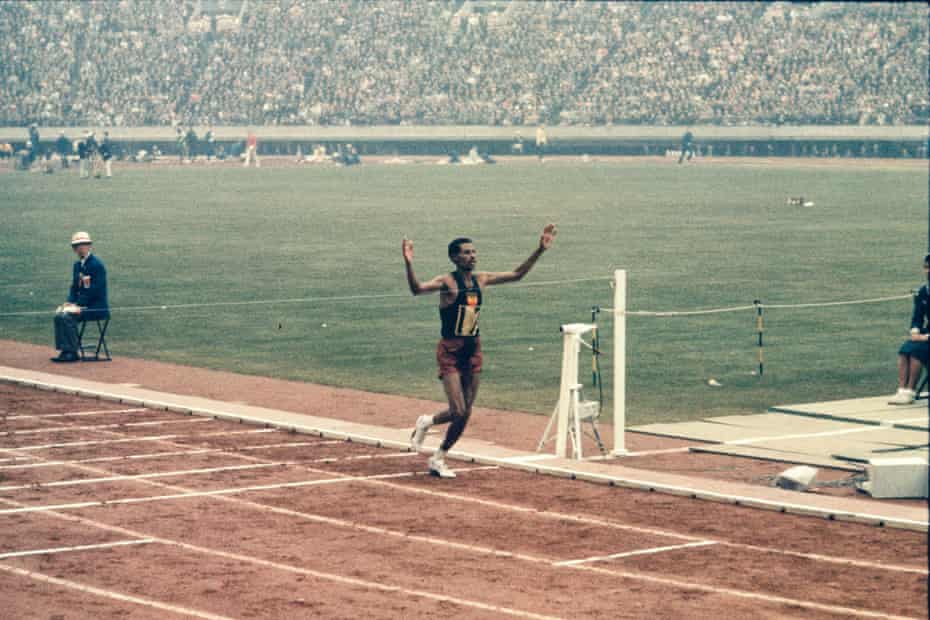 Kon Ichikawa contrasted the joy of marathon winner Abebe Bikila (above), with the pain and distress of the men trailing after him.