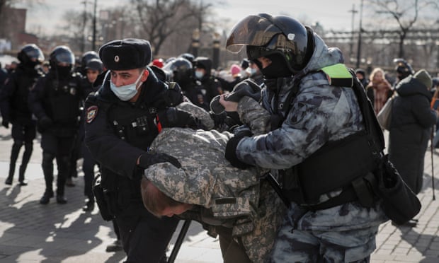 Russian police detain a protestor at a rally in Moscow
