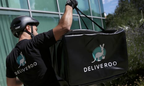 A Deliveroo worker loads his bicycle after making a delivery in London, Britain August 15, 2016.