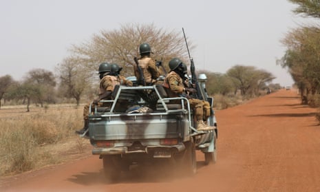 Burkinabe soldiers patrol the road near the town of Gorgadji, in the Sahel area of Burkina Faso.