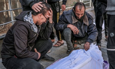 People mourn over the body of a Palestinian killed in an early morning incident on 29 February