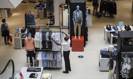 An employee arranges clothing in a John Lewis store. 
