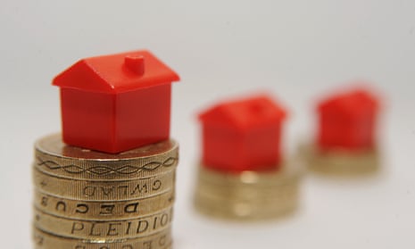 Plastic models of houses on pound coins