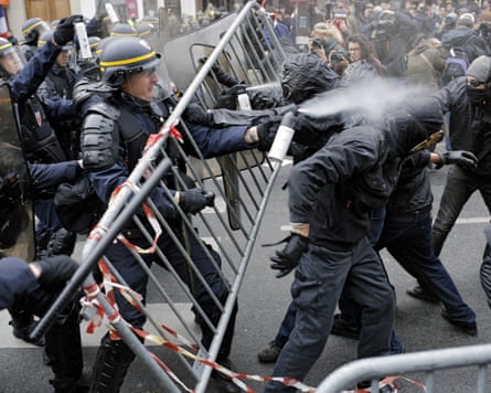 Police fight with activists during a protest ahead of the 2015 Paris climate conference at the place de la Republique, in Paris, Sunday 29 November 2015.