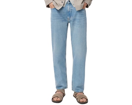 A cropped at waist image of a model wearing Mango Moby stone wash jeans and sandals