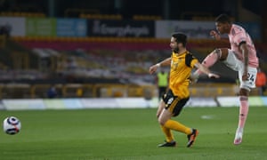 Rhian Brewster of Sheffield United shoots past Ruben Neves of Wolverhampton Wanderers.