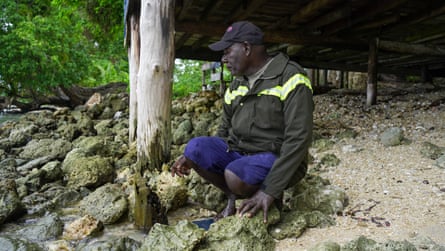 Bobby Soma inspects the rotting foundations of a house he built on Toruar that was once 15 metres from the sea.