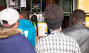 People watch a telenovela from the street