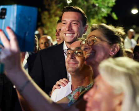 RN president Jordan Bardella (C) poses with supporters in La Seyne-sur-Mer, southern France, on Sunday