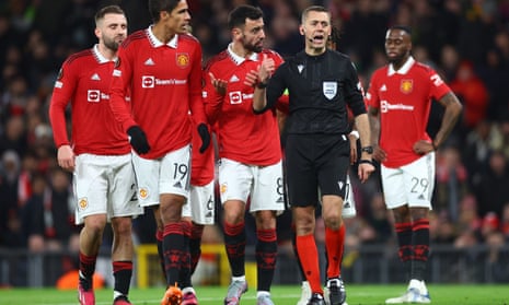 Raphael Varane and Bruno Fernandes protest against referee Clement Turpin after a penalty was awarded