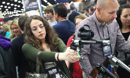 Gun enthusiasts look over Smith &amp; Wesson pistols at the NRA Annual Meetings &amp; Exhibits in May.