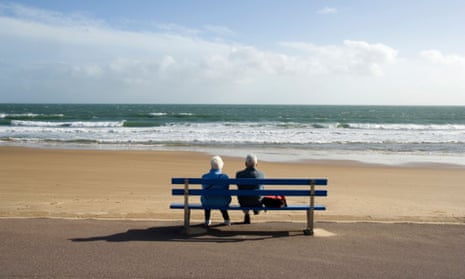 An elderly couple looking out to sea, Bournemouth, Dorset,