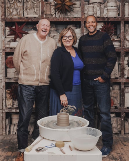 Tarbuck, Brymer Jones and Miller stand in front of a pottery wheel with a half-finished pot on it