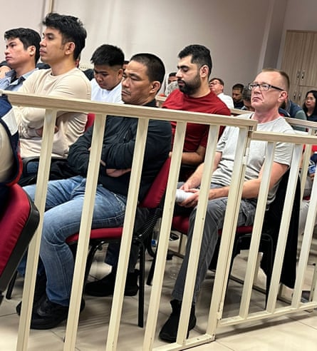 Albokhari (in red T-shirt) in court with fellow Phoenician M crew members arrested for drug smuggling