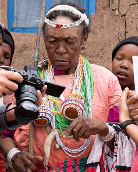 Mathabang Hlaela frowns as she looks at a foldout camera screen